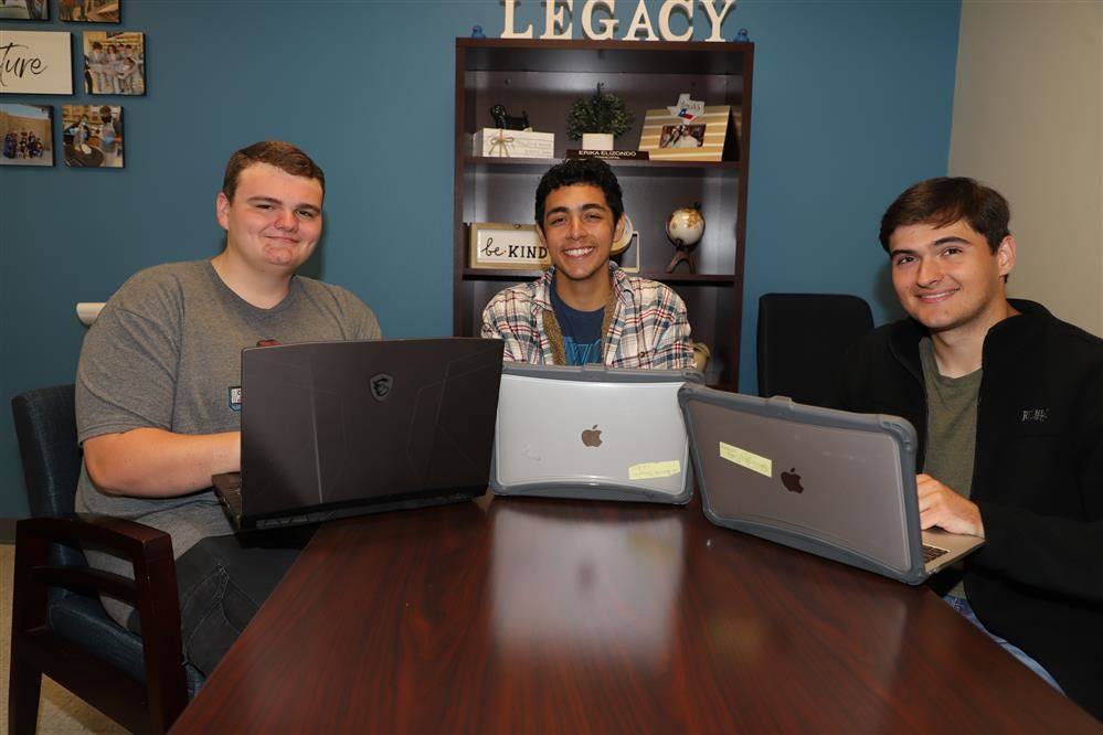  Three students with laptops